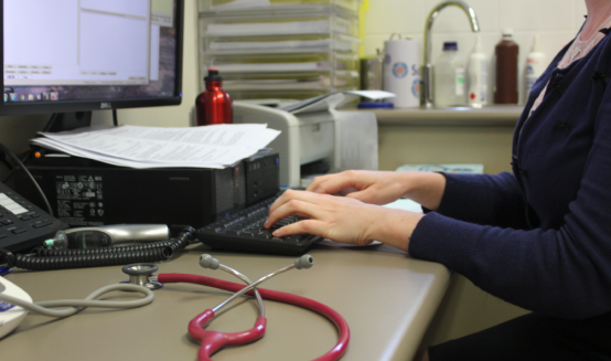 Doctor talking to patient over the internet on computer