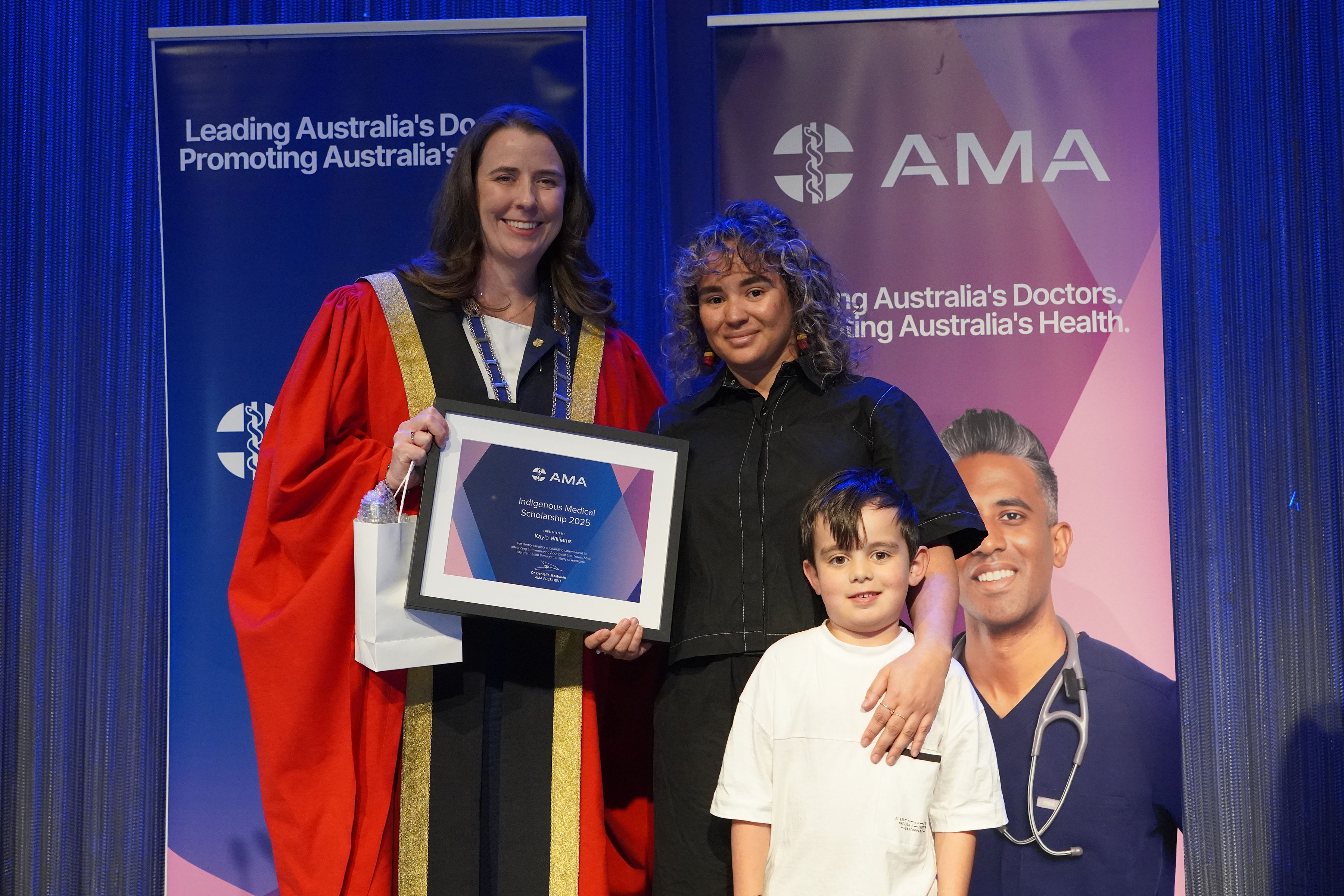 AMA President Dr Danielle McMullen presents Kayla Williams-Tucker (pictured with son Ezra) a 2025 AMA Indigenous Medical Scholarship. Image: AMA