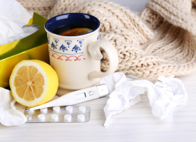 Thermometer, lemon and pain relief medication
