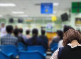 Woman sitting in public hospital waiting room