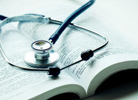 Stethoscope on top of open book