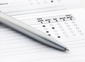 paper survey with pen resting on top