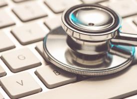 stethoscope on top of laptop