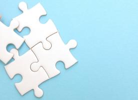 plain white puzzle pieces on blue background