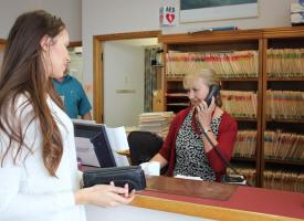 Woman making appointment at doctors office 