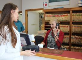 Woman making appointment at doctors office 