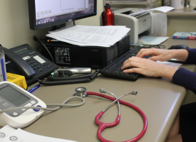 General practitioner writing up notes