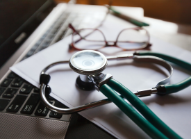 Stethoscope resting on laptop