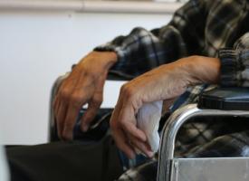 Aged hands on wheelchair 