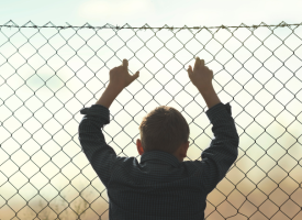 child behind fence