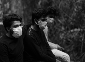 three men with COVID-19 masks in India