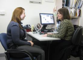A GP in consultation with a woman.