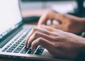 person typing on a laptop
