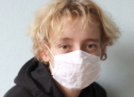 Adolescent with face mask