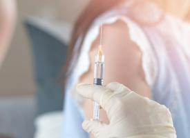 doctor holding syringe