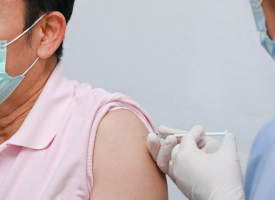 GP giving patient a COVID vaccine 