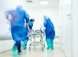 Hospital staff rushing with a gurney