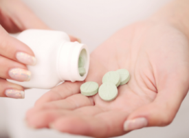 Image of medicines being put into hand