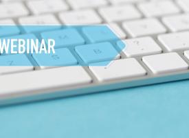computer keyboard with words webinar in banner over