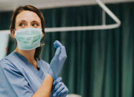 Woman putting on PPE