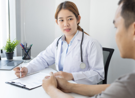 young female doctor consulting with a male patient 