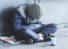 homeless person sitting on street