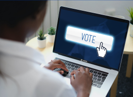 A woman votes on her laptop