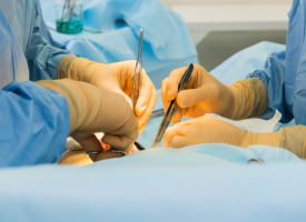 The hands of two surgeons operating