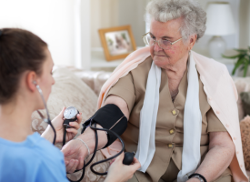 doctor doing a home visit with elderly patient 