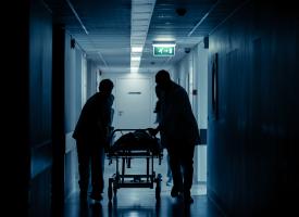 Silhouette of ED workers with stretcher 