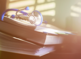 medical volumes with stethoscope on top