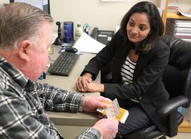 GP speaking to patient in office  