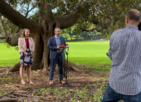 Dr Khorshid and Dr McMullen with camera crew under tree 