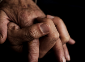 Old couple holding hands