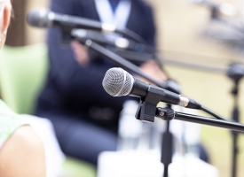 people sitting at microphones
