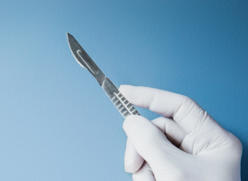 Person holding scalpel