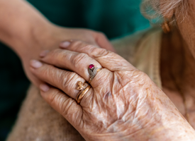 elderly lady being comforted 
