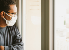 Man looking out window