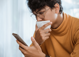 Person with mask and phone