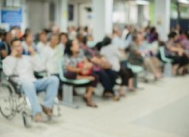 Blurred image of people in hospital waiting room