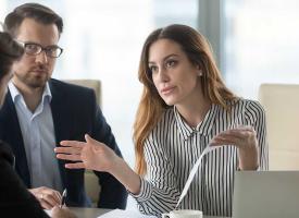 three people in a business meeting.