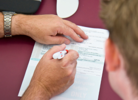 prescription being written by doctor 