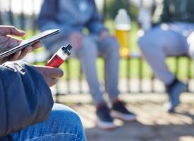 Image of young person vaping in playground