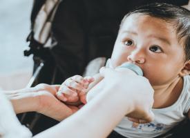 Baby being fed by a bottle