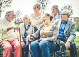 Image of happy older people and woman in wheelchair