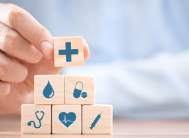 Hand arranging wood block with healthcare medical icon. Health insurance - concept