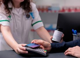 Image of person paying for vitamin supplements