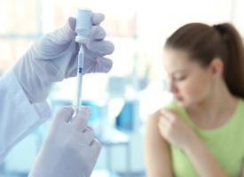 Teen receiving vaccine