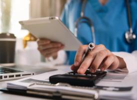 Image of doctor with calculator