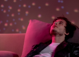 Image of young man with nose bleed in nightclub